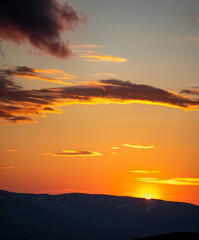 Silhouettes of the Carpathian Mountains against the background of a yellow sunset