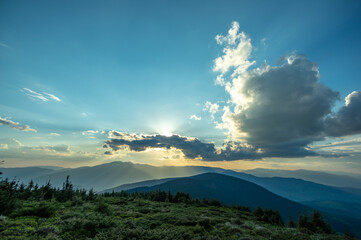 Sun rays and beautiful sky at sunset in the Carpathian mountains