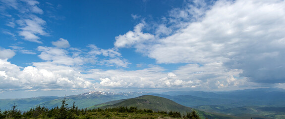 Panorama of blue mountains in spring in the haze