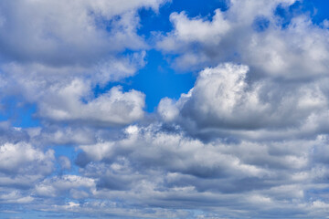 Fototapeta na wymiar White cumulus clouds on blue sky background, natural phenomenon