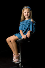 Adorable blonde girl sitting on high chair