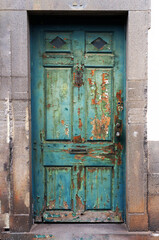Old weathered timeworn shabby door in Funchal, Madeira.