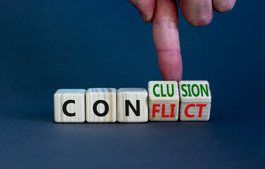 Conflict or conclusion symbol. Businessman turns wooden cubes, changes the word 'conflict' to...