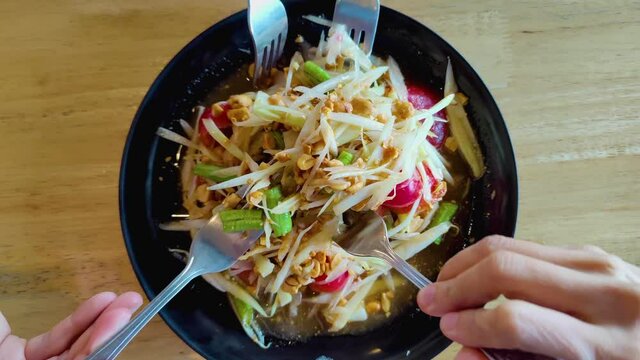Papaya Salad, famous food of Thailand, Asia, the food is spicy because it contains green chili. Put beans with shrimp, healthy style, delicious taste, Thai people like to eat, family eating dinner