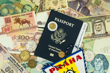 Right angled passport with COVID-19 vaccination card on top of mixed foreign money.