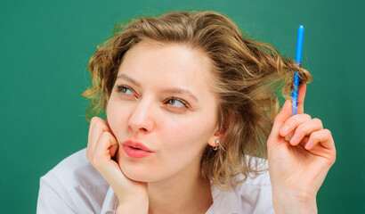 Obraz premium School time. Female teacher in classroom with pen. Back to school. Education concept.