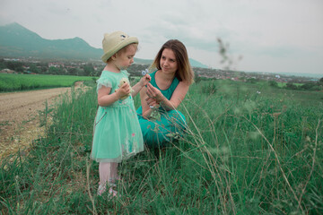 Mom and daughter pick wildflowers