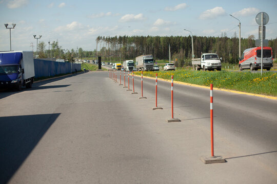 Red parking stops. Fencing the carriageway from cars.