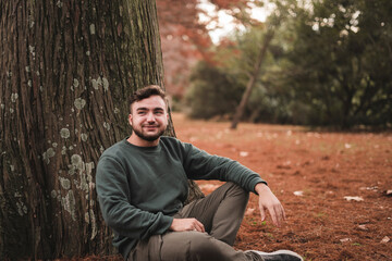 Portrait of a young Caucasian man in a park