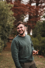 Portrait of a young Caucasian man in a park