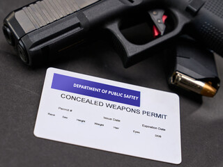 Concealed Carry Permit next to a semi-automatic handgun