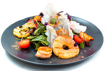 Salad with pineapple grilled shrimp cherry tomatoes basil and rice chips Top view