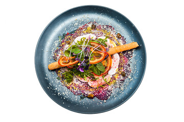 Salad on a black plate isolated on a white background. A dish from the chef. 