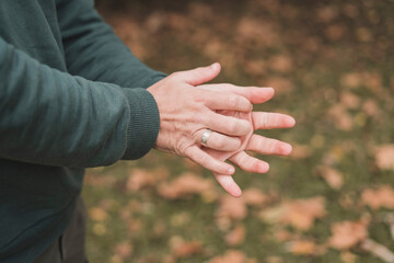 Hands of young man with green sleeves