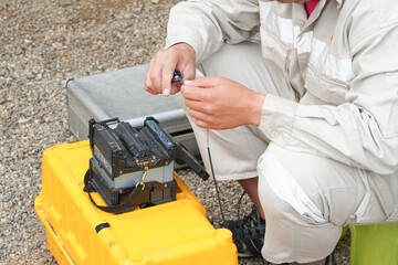 Banner template Technician Fiberoptic Fusion Splicing. Worker connecting for Cable Internet signal and Wire connection with Fiber Optic Fusion Splicing machine,fiber optic cable splice machine in work