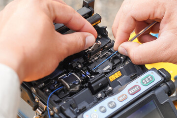Communication system technician checks the data line connection Cable technology Fiber Optic Fusion...