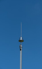 lightning rod on pole, blue sky background,