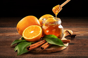Honey with orange and cinnamon on a board