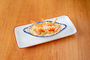 Russian salad with croutons, cooked prawns and hints of avocado on a nice plate