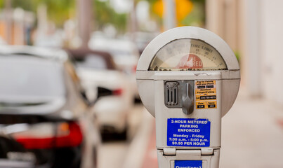 Coin operated parking meter in a downtown area showing expired on the meter