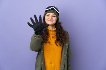 Teenager Russian girl with snowboarding glasses isolated on purple background counting five with fingers