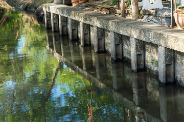 Dirty waste dark black stink bad water smell from city under water pollution process sewer drain pipe dirt sewage water drain to Wastewater Treatment with poor ecosystem and circular economy.