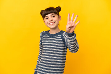 Little caucasian girl isolated on yellow background happy and counting four with fingers