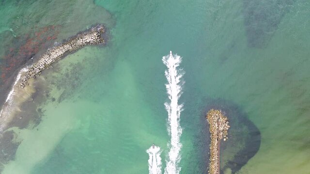 aerial drone of jet skies going fast in ocean
