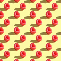 Seamless pattern of raspberry berries on a yellow background.
