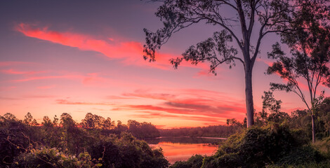 Fototapeta na wymiar Beautiful Panoramic Riverside Sunset with Cloud Reflections