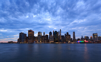 Fototapeta na wymiar New York City sunset view from Brooklyn during blue hours with clouds celebrates Junteenth