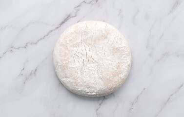 Fresh homemade yeast dough resting on marble table flat lay.