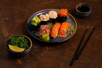 Sushi Set, Sashimi, Rolls Set on Table. Asian Cuisine. Healthy Food. Wakame Salat and Sushi Sticks