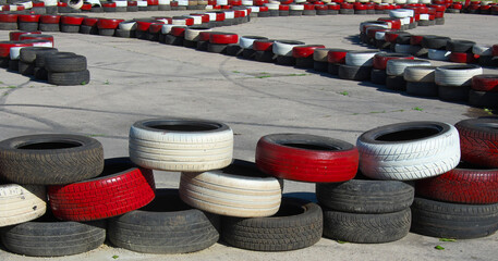 of old black, red and white tires. The trajectory is set. Motion concept. Abstract set with road.