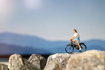 Fotobehang Miniature people : Traveler with bicycle riding on the rock , Travel and Adventure concepts. © Sirichai Puangsuwan