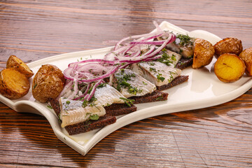 Herring snack with bread and potato