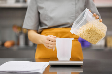 Pastry chef girl prepares the ingredients for her dishes