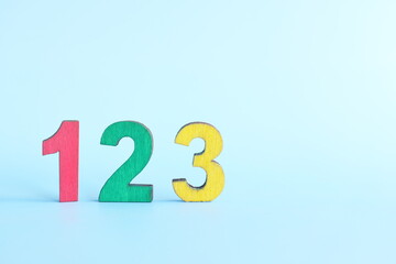 Colorful 123 numbers on wooden blocks in blue background with copy space. Start of child or kid learning counting concept.	 - obrazy, fototapety, plakaty