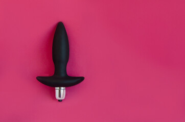Toys for sex. Anal dildos on a pink background. Space for text