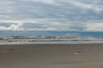 Winter seashore with clouds and waves