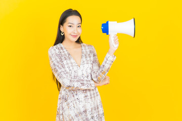 Portrait beautiful young asian woman smile with megaphone