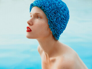 portrait of beautiful woman in pool cap by the water. Summer, swimming, wellness, recreation, travel concept