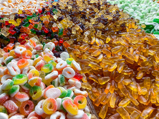 Closeup background from colorful sweets of sugar candies. Assortment tasty gummy