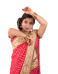 Naklejka premium Beautiful young girl posing in Indian traditional saree on white background.