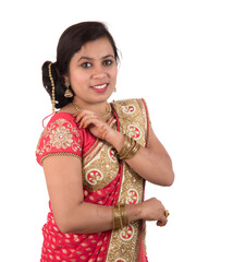 Beautiful young girl posing in Indian traditional saree on white background.