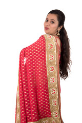 Fototapeta premium Beautiful young girl posing in Indian traditional saree on white background.