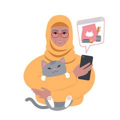 senior lady in headscarf with a cute cat ordering pet supplies online from smartphone.