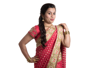 Beautiful young girl posing in Indian traditional saree on white background.