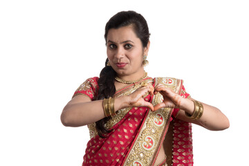 Beautiful young girl posing in Indian traditional saree on white background.