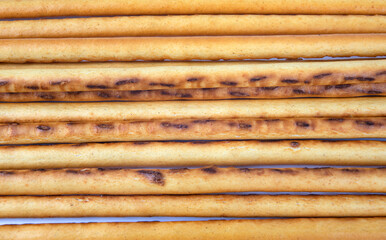 Background from bread sticks. Art bread. Bakery products .